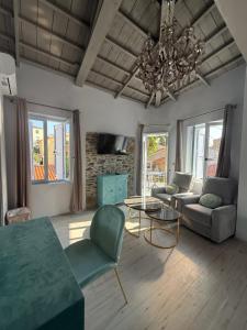 a living room with a couch and a chandelier at Gorgeous restored house at Platanos square in Plomari