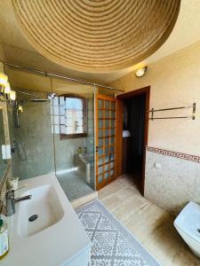 a bathroom with a sink and a shower and a toilet at Très belle villa familiale et romantique/SPA in Agadir