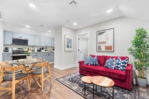 a living room with a red couch and a table at Quiet 2BR Apt, 20 Mins to NYC - Steps to transit in North Bergen