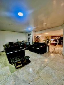 a living room with a couch and a table at Hotel Casa Modelia in Bogotá