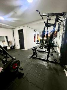 a room with a gym with several tread machines at Hotel Casa Modelia in Bogotá
