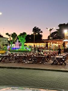 people sitting at tables in front of a fountain at Paraíso Tropical em Porto Seguro in Porto Seguro