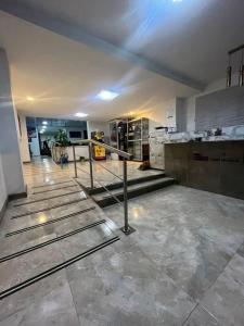 a large room with a staircase in a building at Hotel Casa Modelia in Bogotá