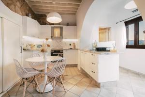 a kitchen with a table and chairs in it at Lindos Zen luxury villa in Lindos