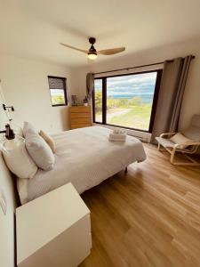 a bedroom with a large bed and a large window at Ten Mile Point Resort in Little Current