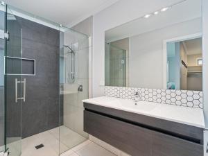 um banheiro com pia e chuveiro em Golden Vista - Coromandel Holiday Home em Coromandel Town mais 22 fotografias