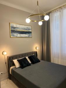 a bedroom with a bed with two lights on it at Pearl of Nice in Nice