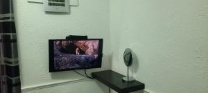 a television sitting on a table in a room at Starlet Single Room in Manchester