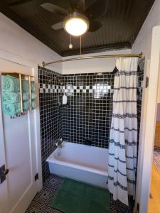 a bathroom with a bath tub and a ceiling fan at Historic Rock House in Helper