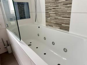 a bathtub in a bathroom with a mirror at Central London Mansion 2 in London