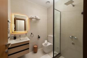 a bathroom with a toilet and a sink and a shower at Giza Capital Hotel in Cairo +30 photos