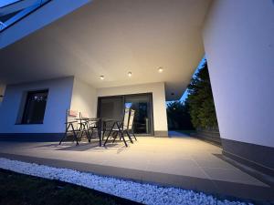 un patio con sillas y una mesa en una casa en Apartment Villa Anima, en Kostrena