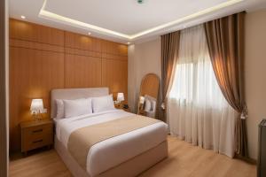 a bedroom with a white bed and a window at Giza Capital Hotel in Cairo