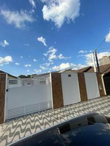 a pair of white garage doors on a building at Pousada Villa Beach Praia Grande in Praia Grande