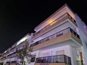 a white building with a balcony on top of it at Staycation Yakout in Mansouria