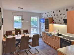 a kitchen with a table and chairs in a room at Zur Teufelsmauer in Vorwerk Helsungen