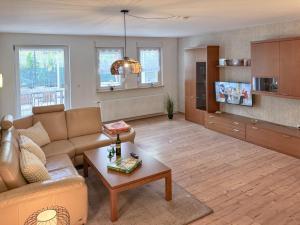 a living room with a couch and a table at Zur Teufelsmauer in Vorwerk Helsungen