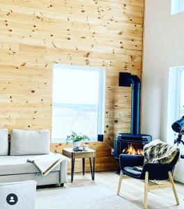 a living room with a couch and a fire place at Ten Mile Point Resort in Little Current +21 photos