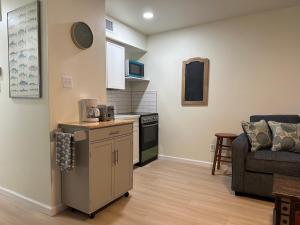 a living room with a kitchen and a couch at 'It's All Good!' in Corpus Christi
