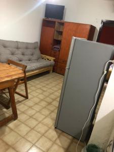 a living room with a couch and a chalk board at Departamento frente al mar y con vistas a la playa in Villa Gesell