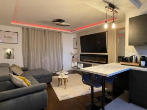a living room with a couch and a table at Appartement Premium - Le Trente in Dijon