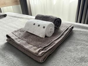 a pile of towels sitting on top of a bed at Apartment Villa Anima in Kostrena