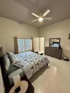 a bedroom with a bed and a ceiling fan at B's Hidden Paradise in Philipsburg +15 photos