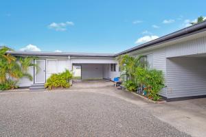a white building with a garage and a driveway at Beach Shack No. 5 in Crescent Head