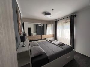 a bedroom with a bed and a large window at Apartment Villa Anima in Kostrena