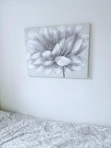 a black and white picture of a flower on a wall at White Rose Double Bed Apartment in Bradford