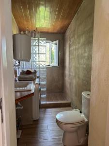 a bathroom with a toilet and a sink and a window at Casa da Travessa in Alte +38 photos