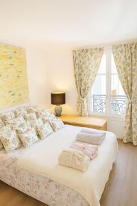 a bedroom with a bed with two towels on it at Spacious Apartment in Montparnasse in Paris