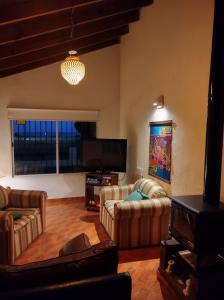 a living room with couches and a flat screen tv at el maiten in Mar del Plata