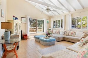 a living room with a couch and a table at Moonflower home in Gregory Town +35 photos