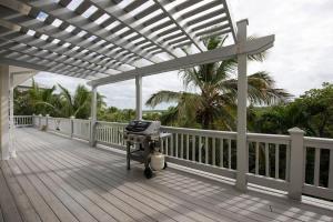a grill on the deck of a house at Salty Dolphin home in Governorʼs Harbour