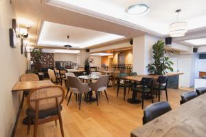 a restaurant with tables and chairs in a room at Hotel 7 SEA Front TLV in Tel Aviv