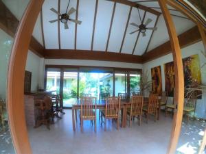 a dining room with a table and chairs at MJ Beautiful sunset beach house in Ban Na We