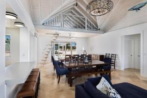 a dining room with a table and chairs and a clock at Buttonwood Reserve Main Lodge home in James Cistern +22 photos