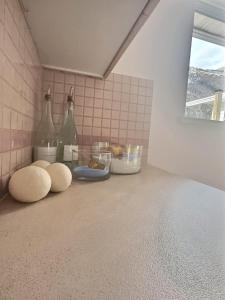 a kitchen counter with two bottles on top of it at Blush Bliss A Peaceful Vineyard Escape in Keremeos +17 photos