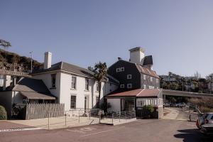 a large white house with a black building at Trevallyn Retreat with River Views in Royal Park