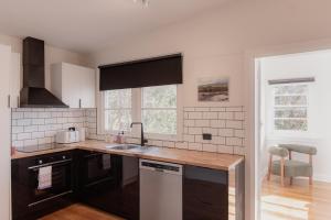 a kitchen with a sink and a counter at Trevallyn Retreat with River Views in Royal Park