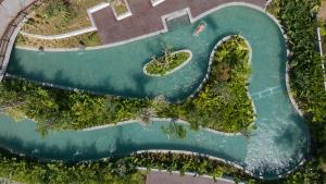 an overhead view of a pool with trees and water at Sumitra Luxury Villas & Resort by Pramana in Sanur