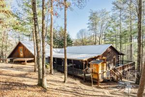 a log cabin in the woods with trees at Aska's Cozy Corner Cabin in Cherry Log