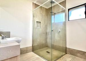 a bathroom with a shower and a sink at Seascape - Kalbarri, WA in Kalbarri +12 photos