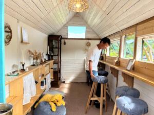 a man is standing in a room in a room at Homey Inn Enya in Yufu