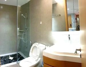 a bathroom with a toilet and a shower and a sink at Seaview shared apartment in Johor Bahru