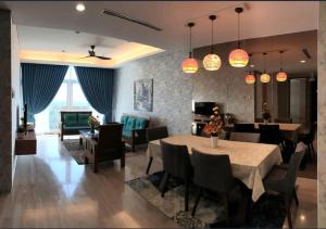 a dining room and living room with a table and chairs at Seaview shared apartment in Johor Bahru