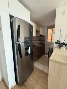 a large stainless steel refrigerator in a kitchen at Confort 203 Apartamento Duitama in Duitama