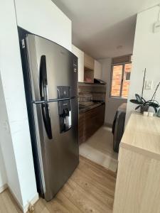 a large stainless steel refrigerator in a kitchen at Confort 203 Apartamento Duitama in Duitama