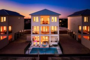 an aerial view of a house at sunset at Miramare - Beachfront Luxury with Pool & Elevator in Orange Beach